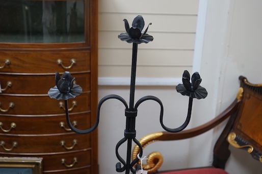 A wrought iron tripod pricket candle stand, height 140cm
